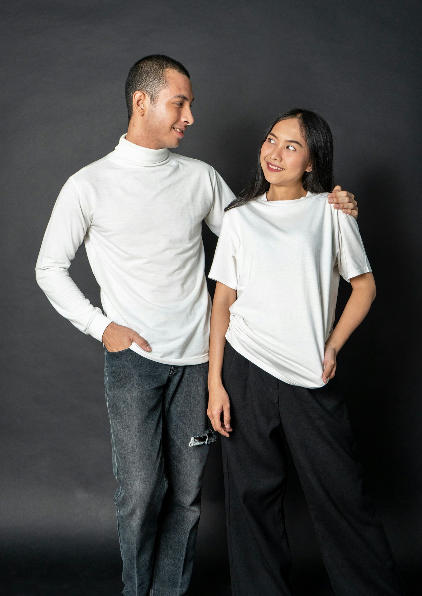 a man and a woman standing next to each other and smiling